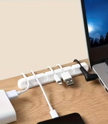 White Silicone Cable Holder with 7 slots organizing USB cords on a wooden desk