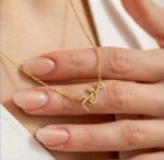 Copper necklace pendant spelling the name Mariam in Arabic calligraphy