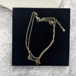 Woman wearing a Letter N Heart Anklet with double layer chain and heart charm