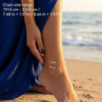 Double layer ankle bracelet featuring an infinity symbol and a letter A charm on a woman's ankle.