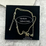 Woman wearing a Letter N Heart Anklet with double layer chain and heart charm