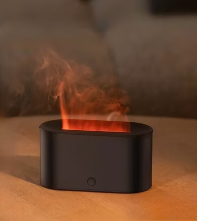 Flame Diffuser Humidifier emitting mist with a realistic LED fire effect on a bedside table