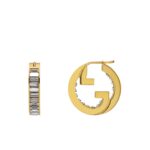 Close-up of Gucci Blondie light gold-toned hoop earrings with crystal embellishments.