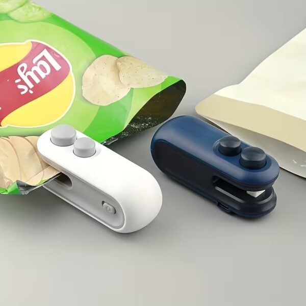 Handheld white mini bag sealer with USB-C port sealing a plastic potato chip bag.