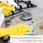 Hand holding a silver disposable square aluminum stove burner cover with a round center hole.