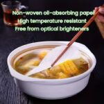 White round oil-absorbing paper mats placed under fried snacks on a plate.