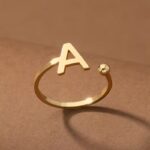 Everly 10k Yellow Gold Initial A Open Ring with April Birthstone flush-set.