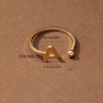 Everly 10k Yellow Gold Initial A Open Ring with April Birthstone flush-set.