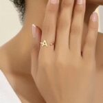 Everly 10k Yellow Gold Initial A Open Ring with April Birthstone flush-set.