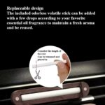 Round wooden car essential oil diffuser with magnetic lid and silicone-protected vent clip.