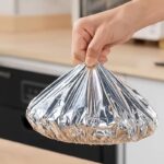 A pack of 50 silver reusable aluminum foil elastic covers for food preservation.