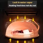 Two clear microwave food box covers over plates of broccoli and salad on a wooden table.