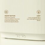 Black electric aroma diffuser with orange LED flame-effect mist.