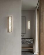 Leldashti waterproof LED wall light with an iron finish and copper accents is mounted on a modern wall.