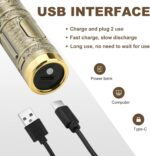 Close-up of a black T-style zero-gap hair clipper with stainless steel blades and guide combs.