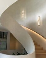 Leldashti waterproof LED wall light with an iron finish and copper accents is mounted on a modern wall.