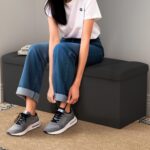 ZETDIY 43-inch black faux linen storage ottoman bench at the foot of a bed