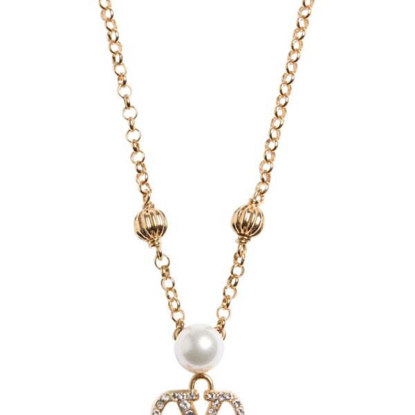 The Valentino Garavani VLogo Signature necklace featuring a pearl and Swarovski crystal pendant on a gold-tone chain.