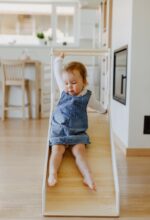 Convertible 3-in-1 kids learning tower shown in stool, desk, and slide positions made of natural birch plywood.