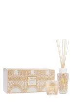 The Paris scented candle and fragrance diffuser are decorated with a powder pink and gold silk-screen print depicting the base of the Eiffel Tower's stylized structure.