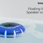 Blue and black InnovaGoods floating wireless speaker floating in a swimming pool