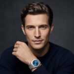 A male model showing the New Bvlgari Bvlgari 41 mm stainless steel watch with a blue dial and engraved logo bezel.