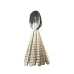 Six polished 20 cm stainless steel spoons arranged neatly on a dark surface