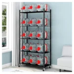 Five-tier black metal storage rack with wheels and cross-braced back standing in a modern kitchen.