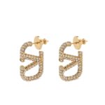 Elevate your style and make a lasting impression with the Valentino Garavani VLogo Signature Earrings, exquisitely crafted in radiant polished gold. These designer earrings blend contemporary elegance with timeless sophistication, featuring the iconic VLogo motif that embodies the luxury and heritage of Valentino. Perfectly suited for both everyday chic ensembles and glamorous evening occasions, they add a refined touch to any outfit while reflecting impeccable taste and fashion-forward sensibility. Lightweight yet striking, these earrings ensure comfort without compromising on style, making them an essential addition to any luxury jewelry collection.