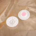 A transparent 60x80cm vacuum storage bag containing a folded blue quilt being compressed by a vacuum cleaner nozzle.