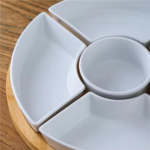 Set of 6 assorted elegant serving plates arranged with snacks and appetizers