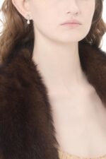 Designer earrings by Valentino Garavani featuring teardrop pearls in a silver setting. Perfect for sophisticated styling and gifting.