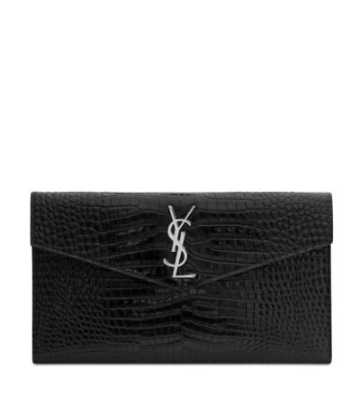Front view of YSL Uptown Pouch in black crocodile-embossed leather with silver YSL initials