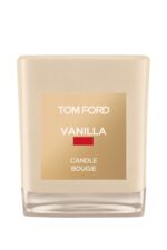 A Tom Ford vanilla-scented candle in a signature vanilla-hued glass jar with a cream label.