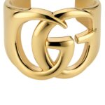 Gucci GG Marmont Cuff Bracelet in polished brass featuring the Double G logo.