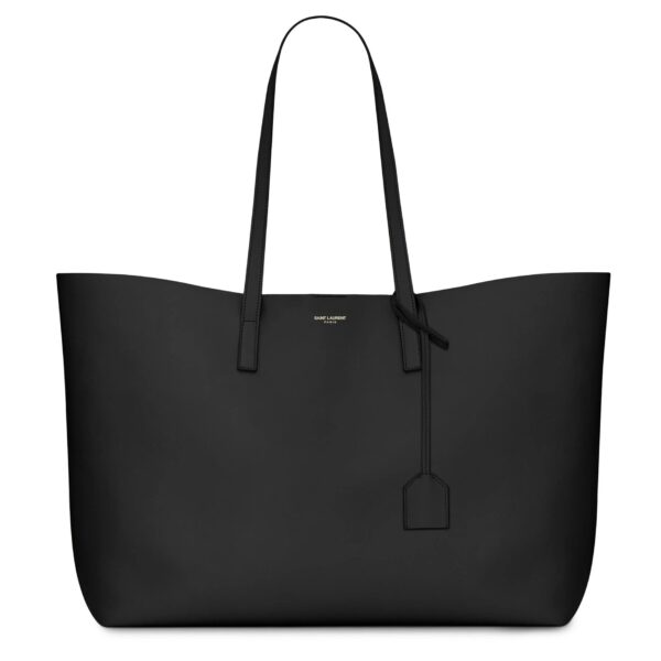Saint Laurent East/West black leather tote bag with gold YSL charm and detachable pouch.