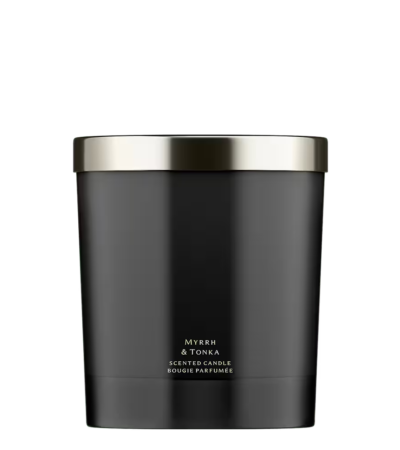 A minimalist black glass Jo Malone London Myrrh & Tonka Home Candle on a neutral background.