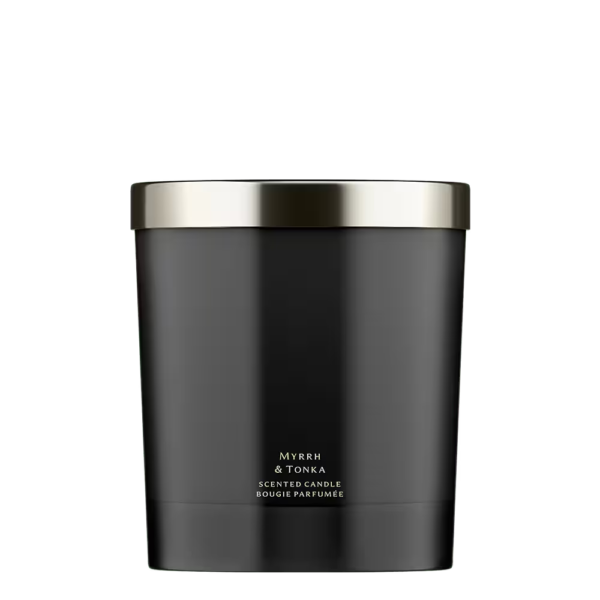 A minimalist black glass Jo Malone London Myrrh & Tonka Home Candle on a neutral background.