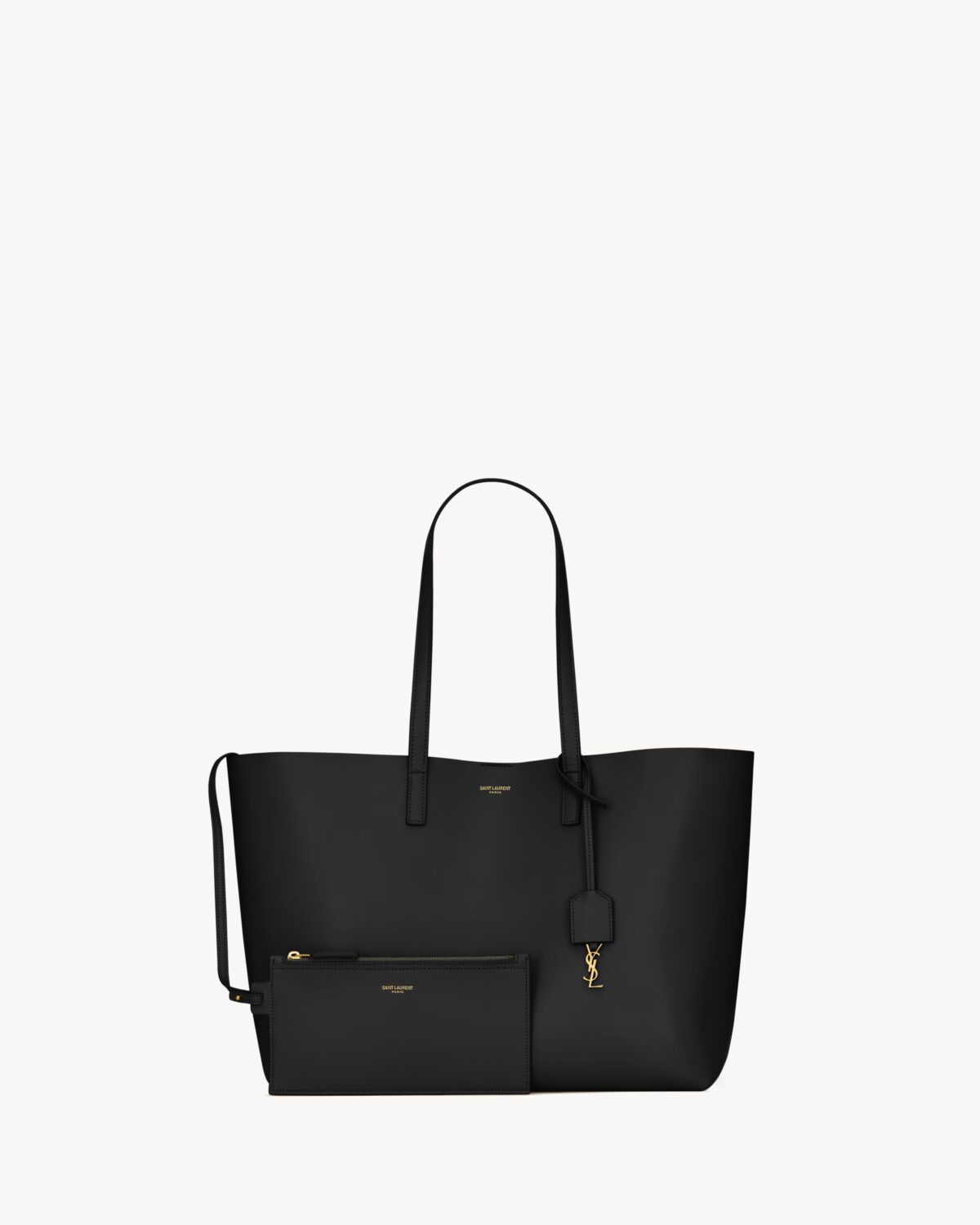 Saint Laurent East/West black leather tote bag with gold YSL charm and detachable pouch.