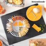 Orange and grey microwave chip maker tray with sliced potatoes and mandolin