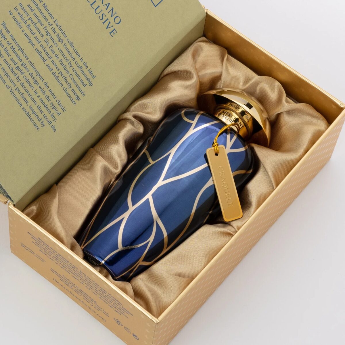 The Merchant of Venice Craquele 100 ml perfume bottle in gold and blue with a hanging metal label.