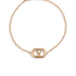 Valentino Garavani Ovalette gold-tone bracelet featuring a Swarovski pearl and VLogo emblem.