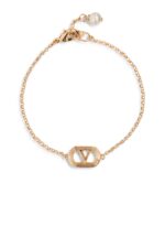 Valentino Garavani Ovalette gold-tone bracelet featuring a Swarovski pearl and VLogo emblem.