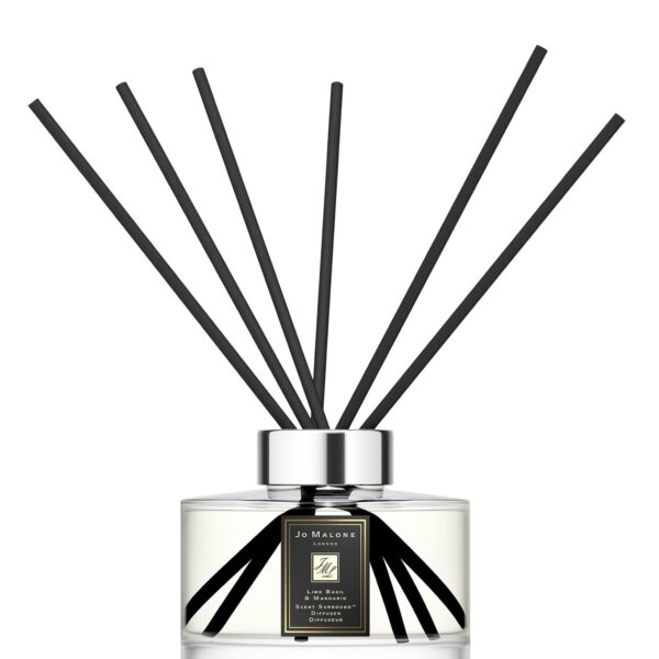 Sleek glass citrus diffuser bottle with 10 black reeds on a minimalist background.