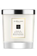 A clear glass Jo Malone London Peony & Blush Suede candle with a silver lid.