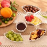 Set of 6 assorted elegant serving plates arranged with snacks and appetizers