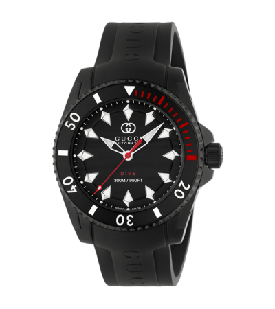 Gucci Dive watch with black dial, Interlocking G logo, and black rubber strap