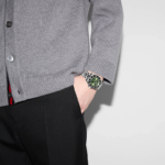 Close-up of Gucci Dive YA136363 watch featuring a green dial and stainless steel bracelet.