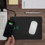 Black leather-style mouse mat with integrated wireless charging zone and smartphone