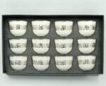 Set of 12 traditional white Arabic coffee cups arranged on a serving tray